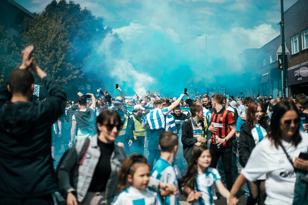 Crowd of fans cheering at a live event